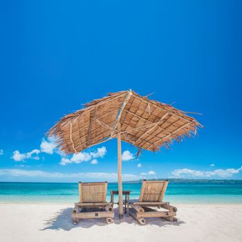 Beautiful tropical sea beach with chaise lounge