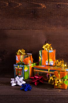 Christmas boxes with ribbons on planks background