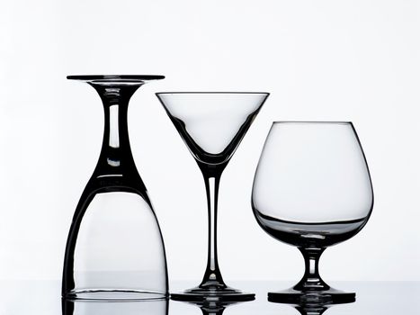 Three Various Empty Wine Glasses for Wine, Martini and Cognac with Reflection on Glass and Shadow Backlight 