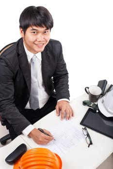 architect man working on drawing table smiling with happiny face isolated white background