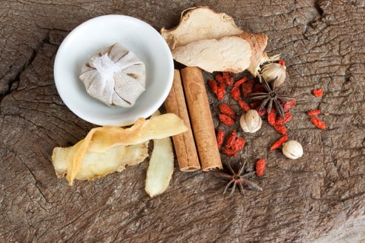 Spices chinese food and herbal wrap for stewed on old wood background