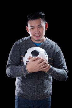 face of soccer lover holding football ball isolated black background use for sport and people activities theme 