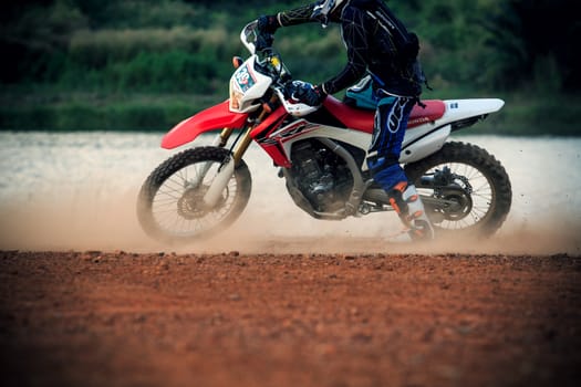 man riding enduro motorcycle on dirt track