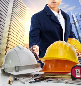 engineer man and working table against sky scrapper in urban scene use for land development and architecture occupation theme