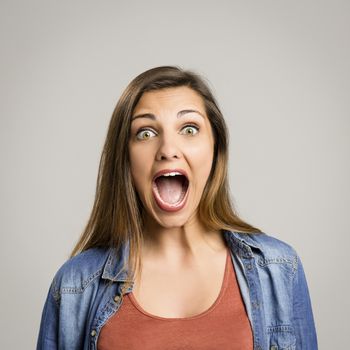 Portrait of a beautiful woman shouting very loud