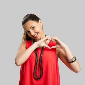 Portrait of a beautiful woman making the heart shape with her hands