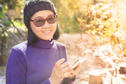 asian woman with smiling face happiness emotion and smart phone in hand use for people and digital technology