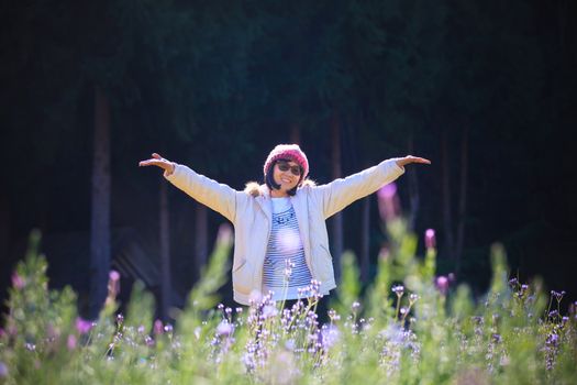 portrait of happiness asian woman with smiling face in blooming flowers garden use for relaxing people in vacation traveling