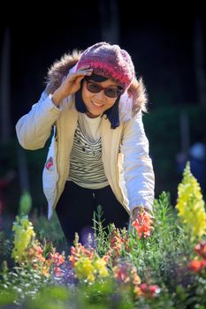 portrait of happiness asian woman with smiling face in blooming flowers garden use for relaxing people in vacation traveling