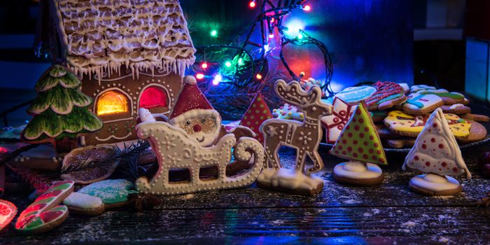 Gingerbreads for new years and christmas on wooden background, xmas theme