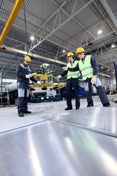 Workers working with aluminium billets at CNC machine shop