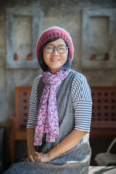 portrait of 40s years asian woman wearing wool hood and silk scarf toothy smiling with happiness emotion 