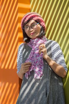 asian woman wearing wool hood and silk scarf in winter season standing under shadow and light from open home roof use for woman and effect of sun light,and beauty issue related