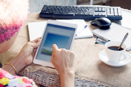 woman and tablet computer in hand sliding on touching screen use for people and lifestyle in digital technology