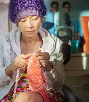 woman with smiling face happiness emotion knitting working at home