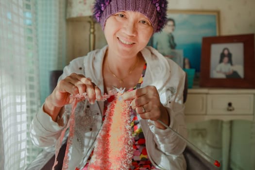 woman with smiling face happiness emotion knitting working at home