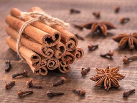 Set of cinnamon, clove and star anise on wooden background. Close up