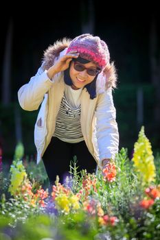 portrait of happiness asian woman with smiling face in blooming flowers garden use for relaxing people in vacation traveling