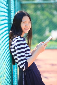 asian girl and computer tablet in hand standing with toothy smiling face use for people and internet connecting ,communication in modern digital lifestyle