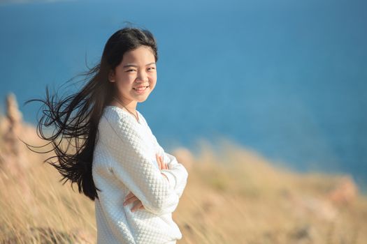 portrait of young asian girl  smiling face happiness emotion with blue blur background 