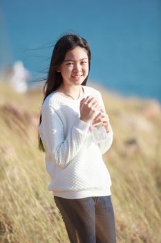 portrait of young asian girl  smiling face happiness emotion with blue blur background 