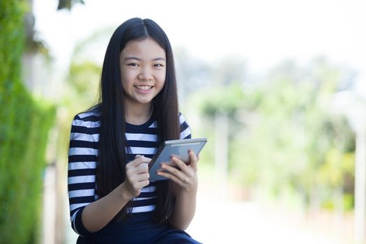 portrait of asian teen and computer tablet in hand use for digital lifestyle ,internet wifi and on line business communication