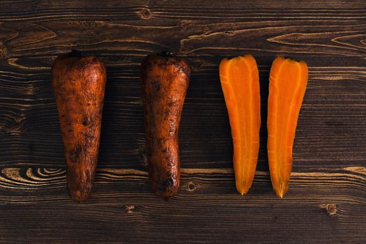 Boiled carrots on dark wooden background