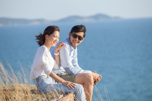 portrait of asian younger man and woman relaxing vacation at sea side happiness emotion