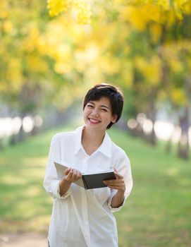 portrait of young asian woman and book in hand rising hand as victory with happiness face emotion use for people success in education and business 