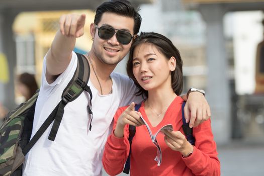 portrait couples of asian younger man and woman backpacker traveling to destination location