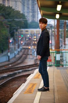 Asia man waiting train at outdoor