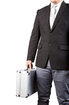 young business man holding stong metal suitcase isolated white background