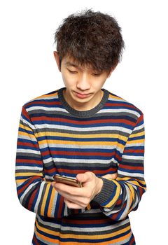 Young man using mobile phone texting on white background