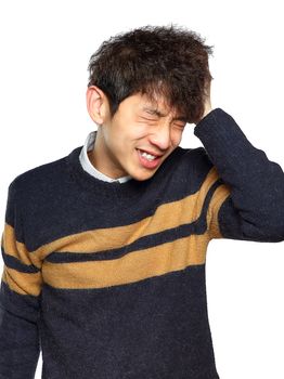 Closeup portrait, stressed young asian man, hands on head with bad headache, isolated background on white. Negative human emotion facial expression feelings.