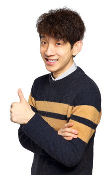 Young laughing asian man showing thumb up hand gesture isolated on white background