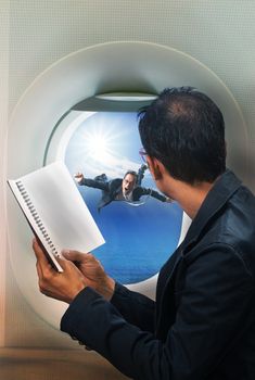 business man reading book in passenger plane seat and looking to out side of plane see another buseness man flying beside a window