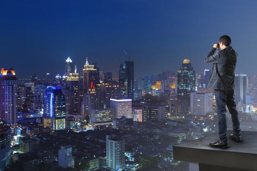 business man and binocular spying watching to another building use for business strategy for successful conceptual theme