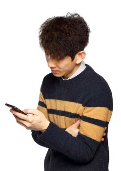 young asia man texting on mobilephone, thinking and looking away.