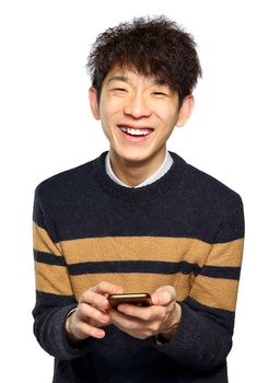 Young man using mobile phone texting on white background