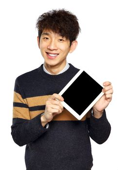 Handsome young Asian man using tablet / pad on white background