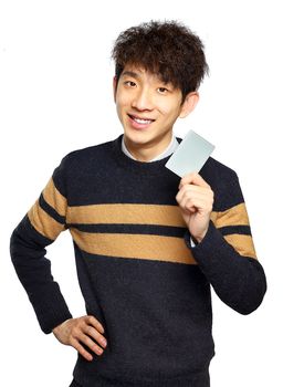 Asian young man holding card on white background