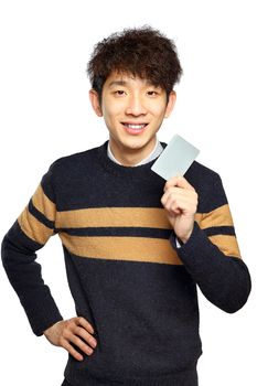 Asian young man holding card on white background