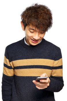 Young man using mobile phone SMS on white background