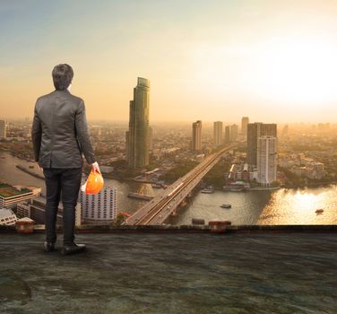 engineering man standing on top of building looking to urban scene dreaming to new project