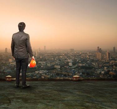 engineering man standing on top of building looking to urban scene dreaming to new project