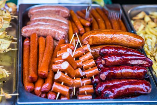 delicious Fried different kinds of sausages on a board