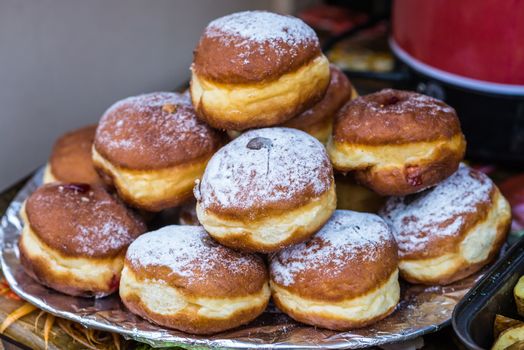 delicious doughnuts on a plate sprinkled with icing