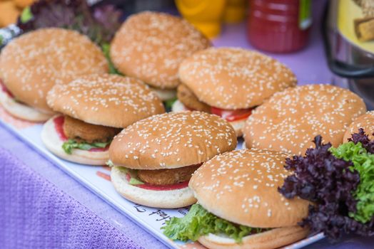 delicious burgers on the Board prinkled with sesame seeds