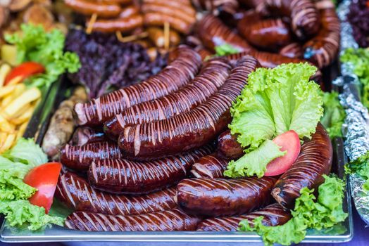 delicious Fried different kinds of sausages on a board