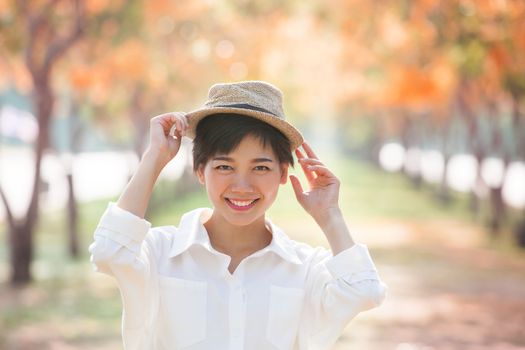 portrait of couples beautiful asian woman standing in blooming flowers park with happiness emotion